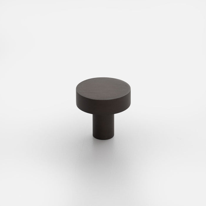 Front view of Edgecliff Knob showcasing a dark cylindrical knob with a wide round top on a white background