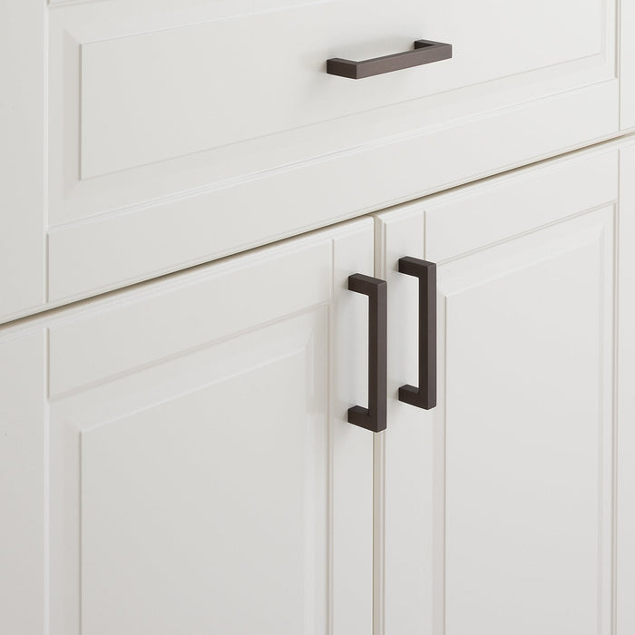 Close-up of Edgecliff Pull showcasing rectangular bar design with white paneled cabinetry