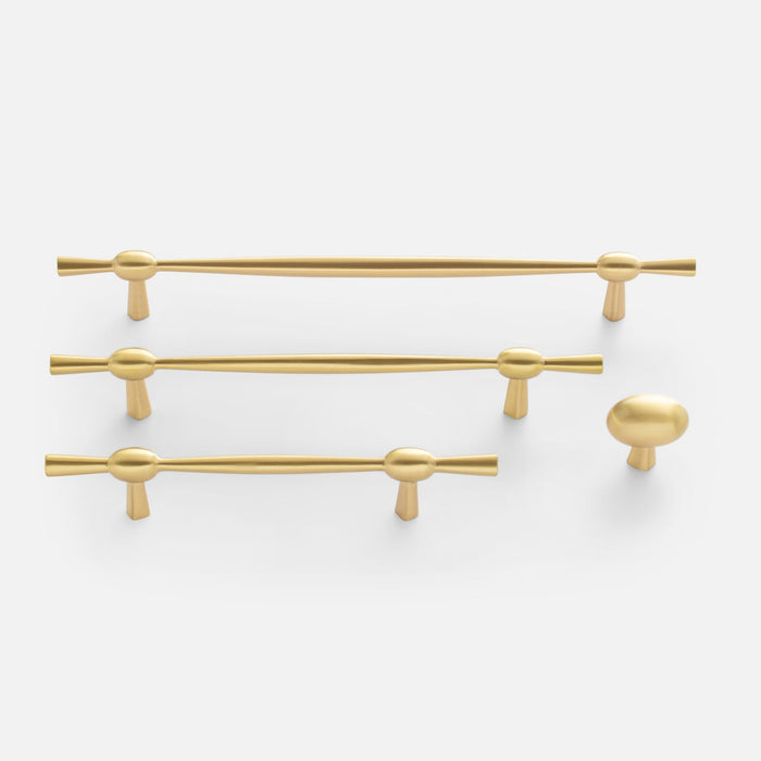 Front view of Eleanor Pull in natural brass showcasing curved bow tie design in multiple sizes on white background