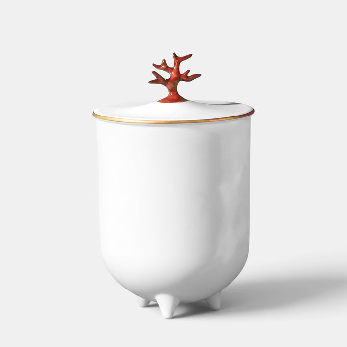 L'Objet footed white porcelain candle with a red coral lid and 24K gold rim accents.