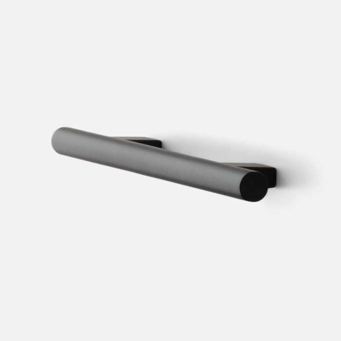 Angled view of Galley Pull showcasing its cylindrical bar and mounting bases in True Black finish on a white background