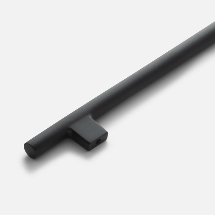 Angled close-up of the Galley Pull showcasing its asymmetrical intersecting curves in a black finish on a white background