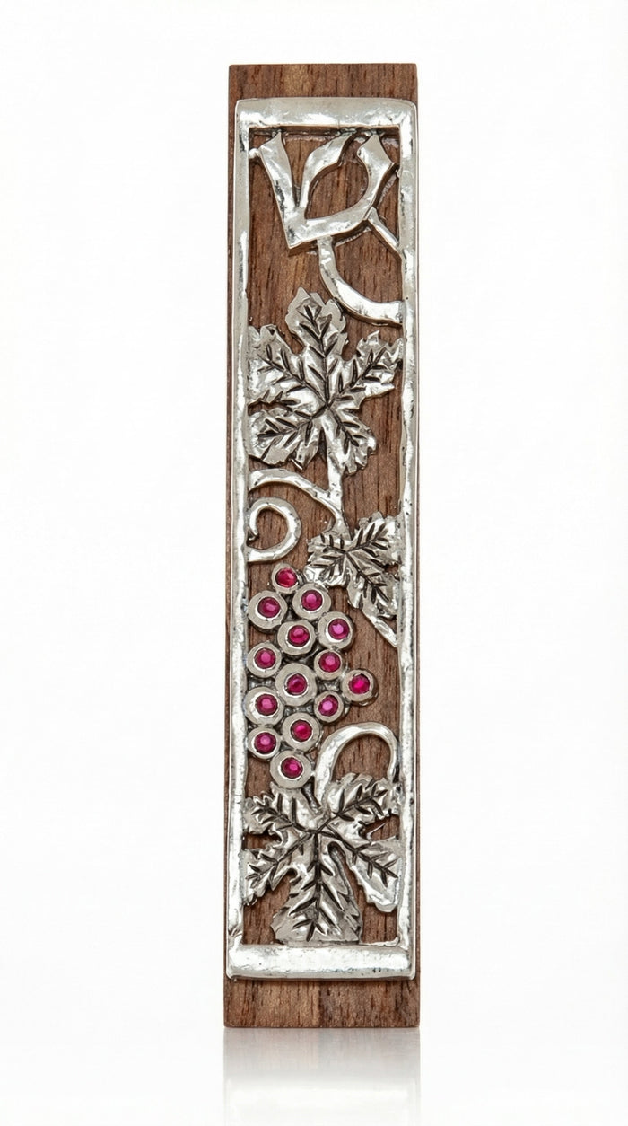 Mahogany Mezuzah with curling pewter vine and maroon stones depicting the holy land, shown on a white background with soft reflection.