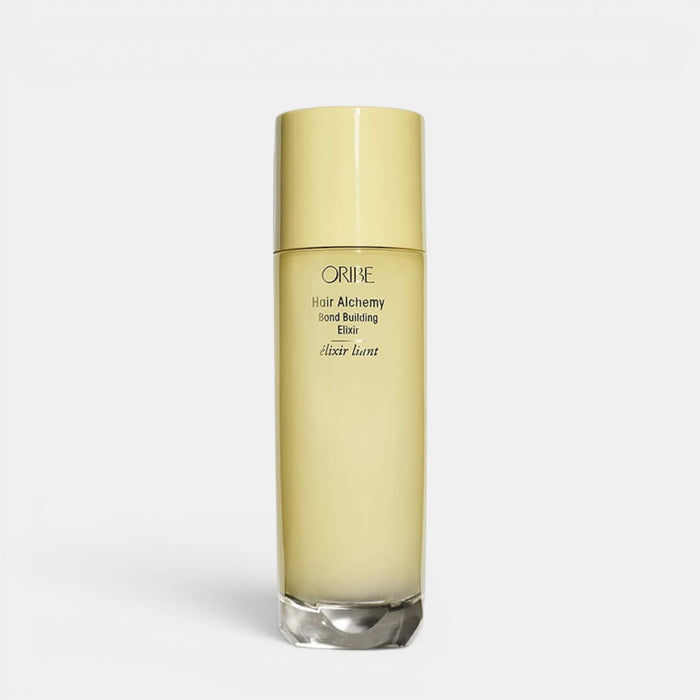 Shop Rescue Spa Oribe Hair Alchemy Bond Building Elixir in a tall, pale yellow cylindrical bottle.