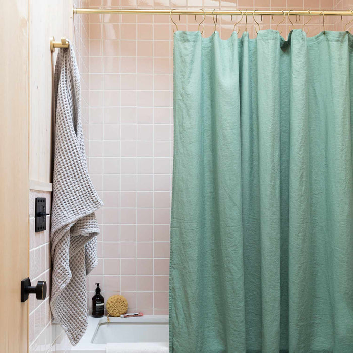 Front view of Linen Bath Textiles shower curtain showcasing textured 100% linen in Laurel with a tiled bathroom background