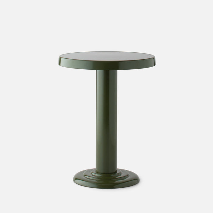 Close up front view of Owen Side Table showcasing glossy forest green round top and cylindrical pedestal base on a white background