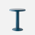 Close-up front view of Owen Side Table in Pool-Gloss showing round top and cylindrical base on light gray background