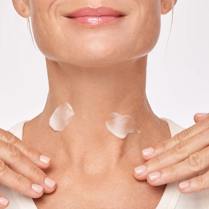 Shop Rescue Spa Restorative Neck Complex cream applied to a woman's neck and décolleté for skin tightening