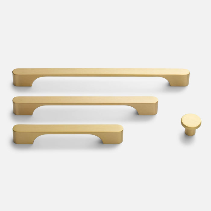 Front view of Roland cabinet knob in natural brass shown with matching cabinet pulls on a white background