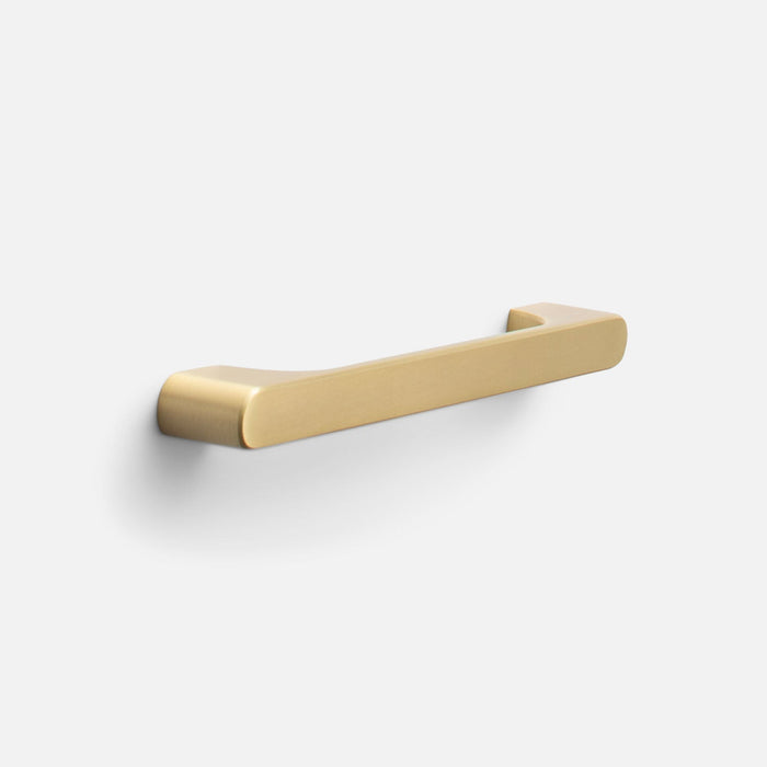 Three-quarter view of Roland Pull showcasing its natural brass finish and rounded rectangular bar on a light gray background
