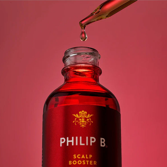 Shop Rescue Spa Philip B. Scalp Booster Pre-Wash serum in a red glass bottle with a gold dropper on a red background.