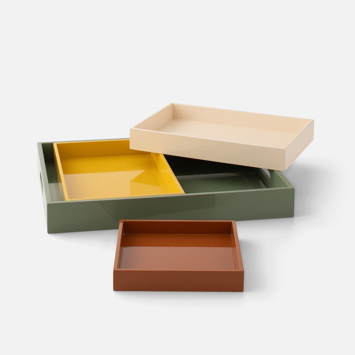Angled view of Stacking Trays, Set of 4 showcasing four nesting lacquered trays in muted colors on a white background